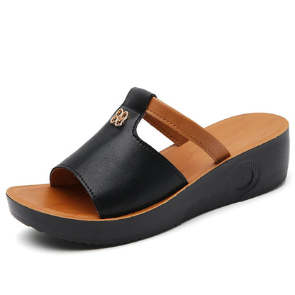 Women's black and tan platform slide sandals with cutout detail and wedge heel for comfort and style