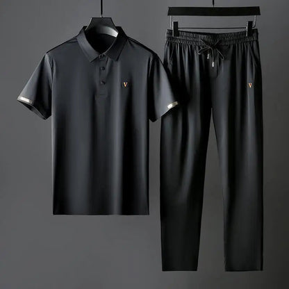 Black men's Viero polo shirt and drawstring pants matching set with gold V logo and decorative sleeve trim