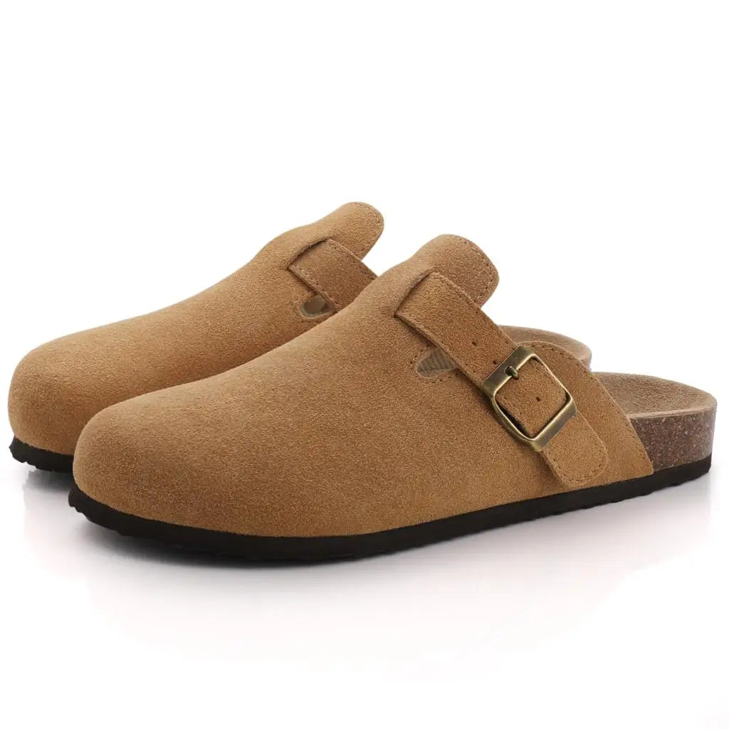 Tan suede slip-on clogs for men with gold buckle strap, cork footbed, and dark rubber sole.