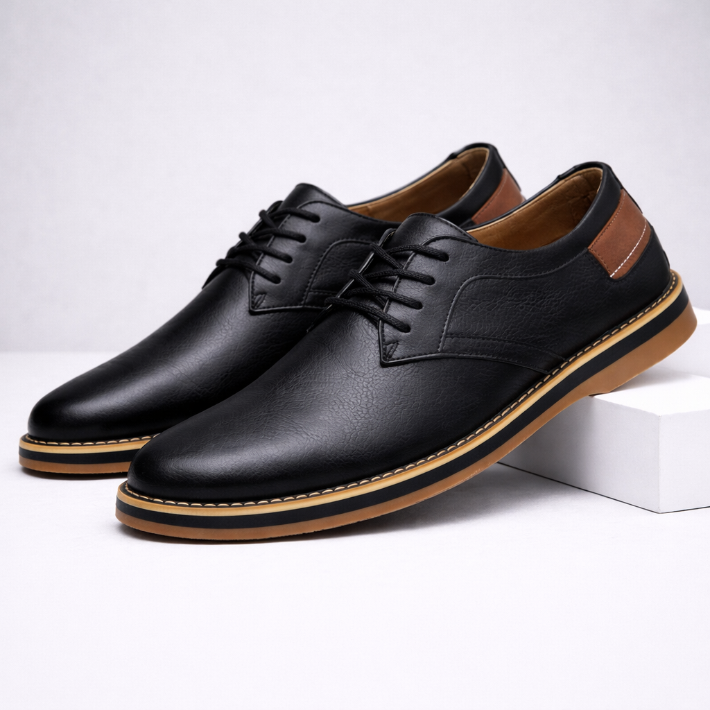 Black men's leather lace-up dress shoes with tan sole, brown heel accent, and three-eyelet lacing on white background.
