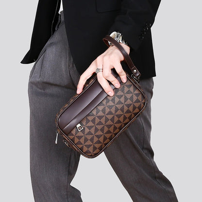 Brown checkered crossbody bag with adjustable strap held by person in gray pants and black jacket