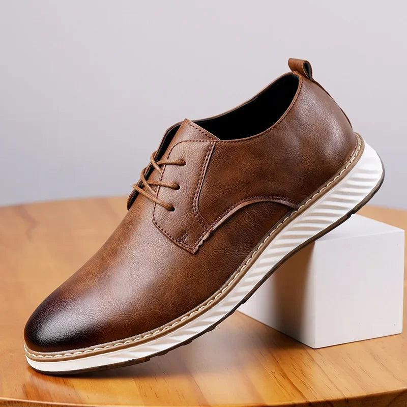 Brown leather orthopedic sneakers with white sole and lace-up design displayed on wooden block stand