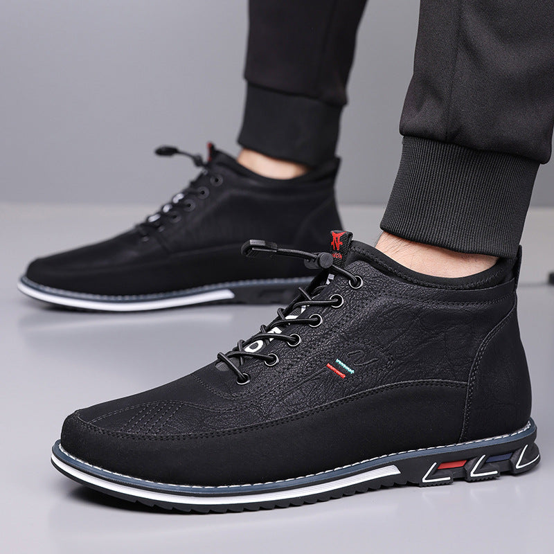 Black Torven leather mid-top men's sneakers with lace-up closure, contrast sole, and subtle texture detailing, worn with black joggers.