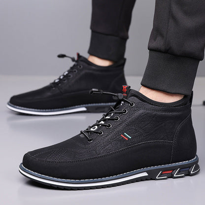 Black Torven leather mid-top men's sneakers with lace-up closure, contrast sole, and subtle texture detailing, worn with black joggers.