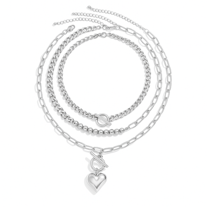 Silver layered chain necklace set with curb, bead, and paperclip chains plus toggle clasp heart pendant