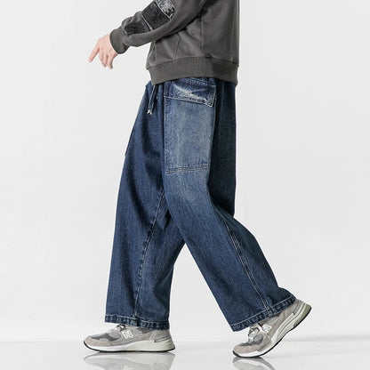 Men's wide-leg denim jeans with relaxed fit, side pockets, and rolled cuffs in dark blue wash