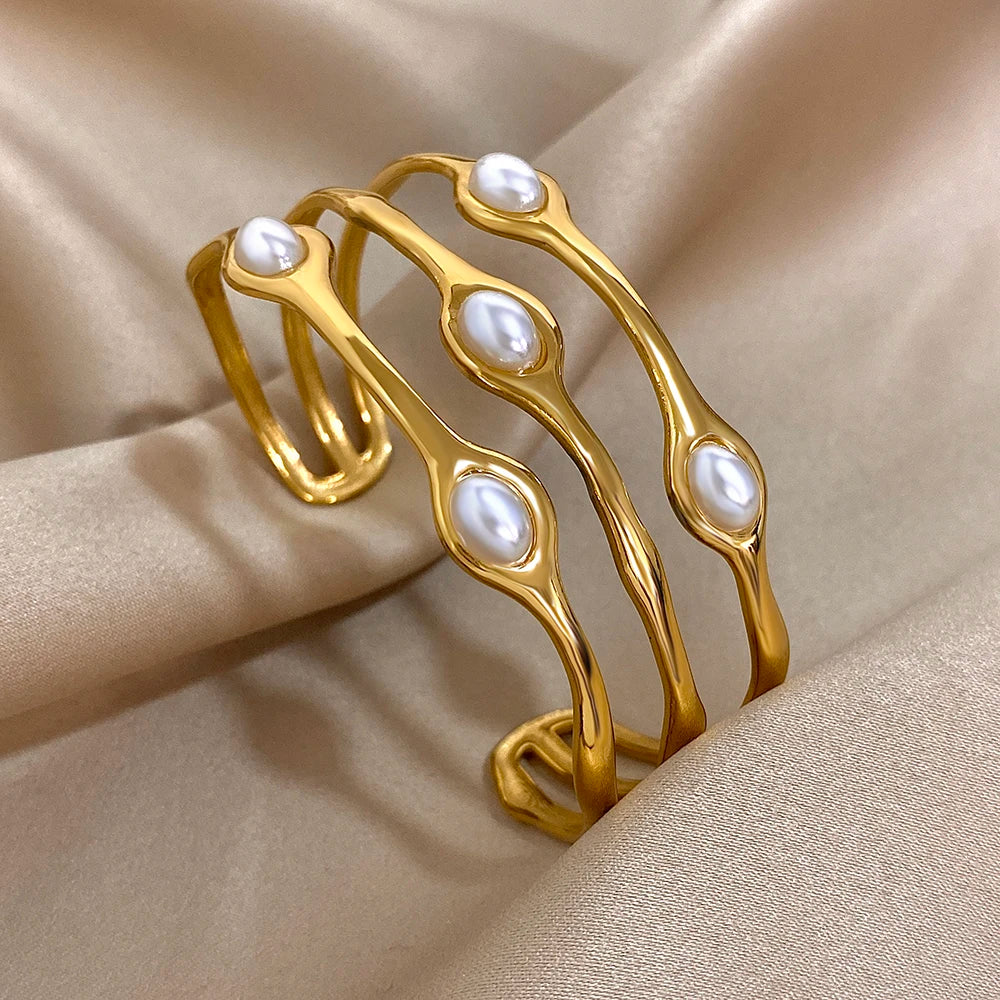 Gold tone pearl cuff bracelet with organic wavy design and white baroque pearls for women