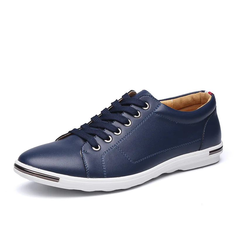 Navy blue men's leather low-top lace-up sneakers with white sole, gold eyelets, and tan interior lining.