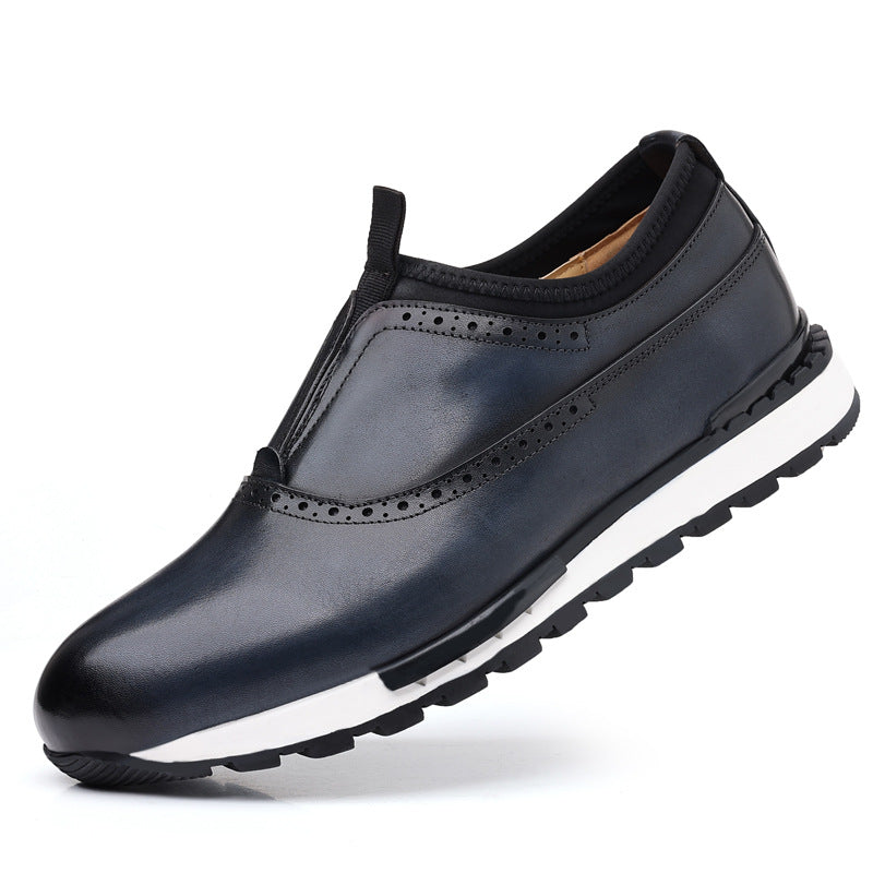 Navy blue leather slip-on men's loafers with brogue perforations, black collar, and white rubber sole