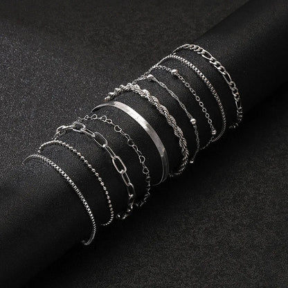Silver chain bracelet set featuring 10 mixed styles including box, figaro, rope, beaded, and paperclip chains on black background