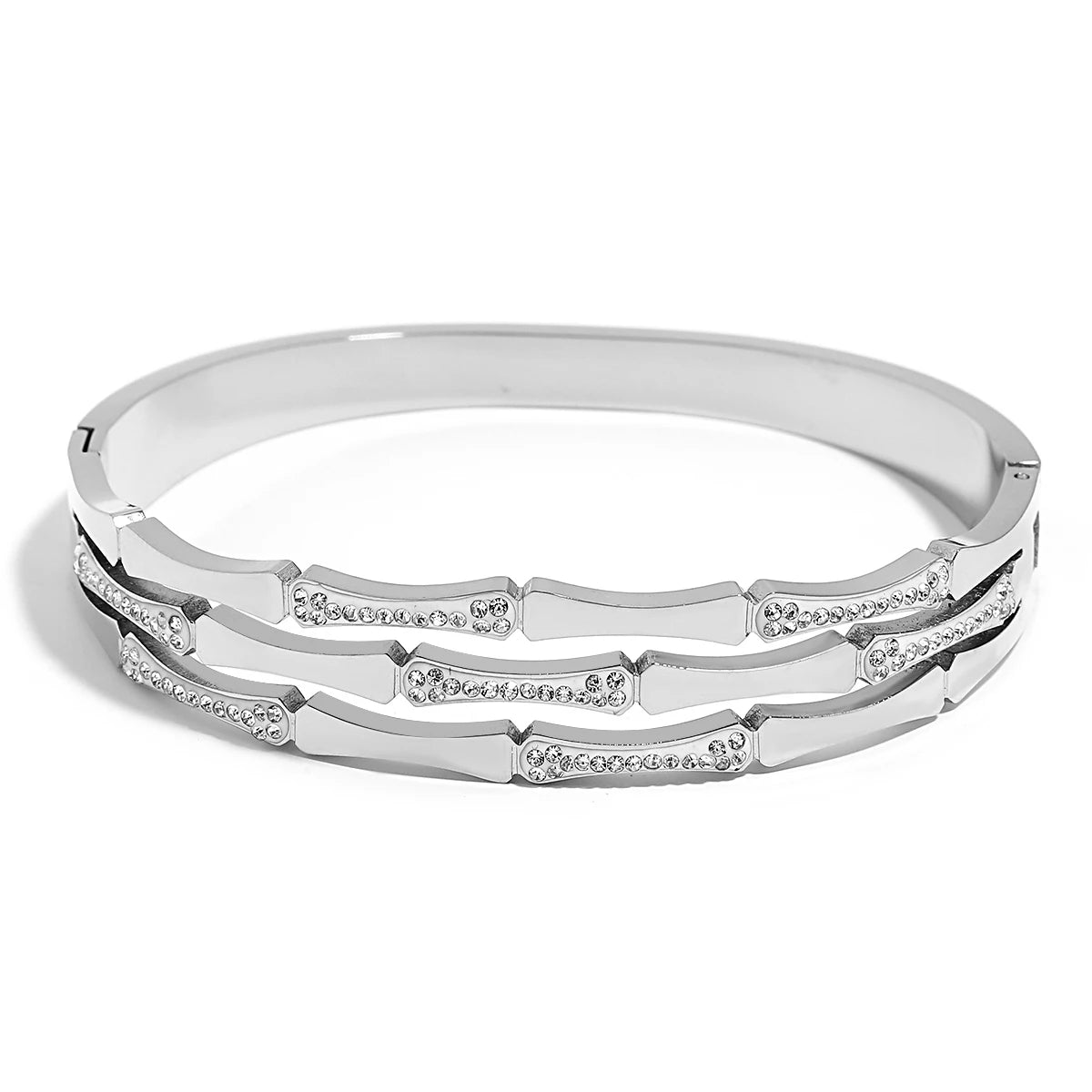 Silver tone bangle bracelet with geometric segmented design and sparkling crystal stone accents throughout