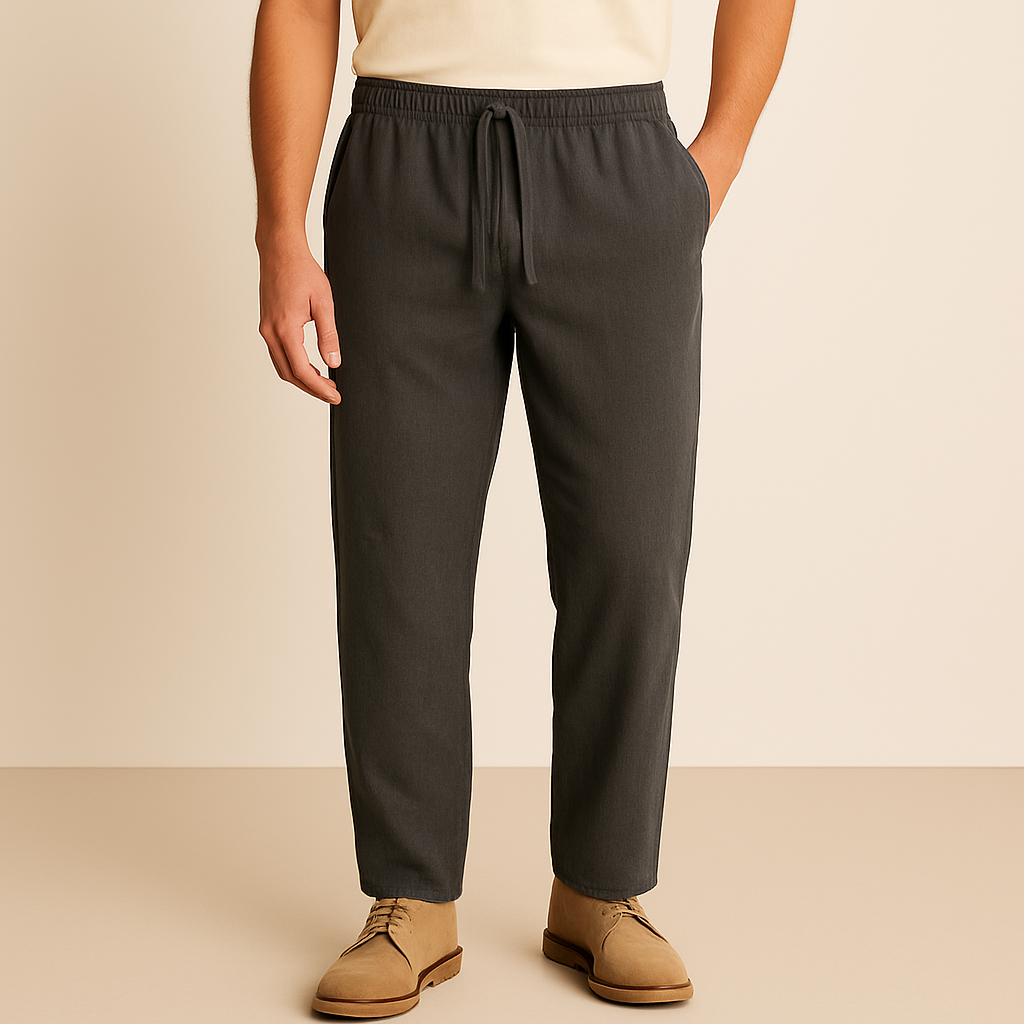 Men's dark gray linen-cotton drawstring pants with elastic waist and relaxed fit on beige background