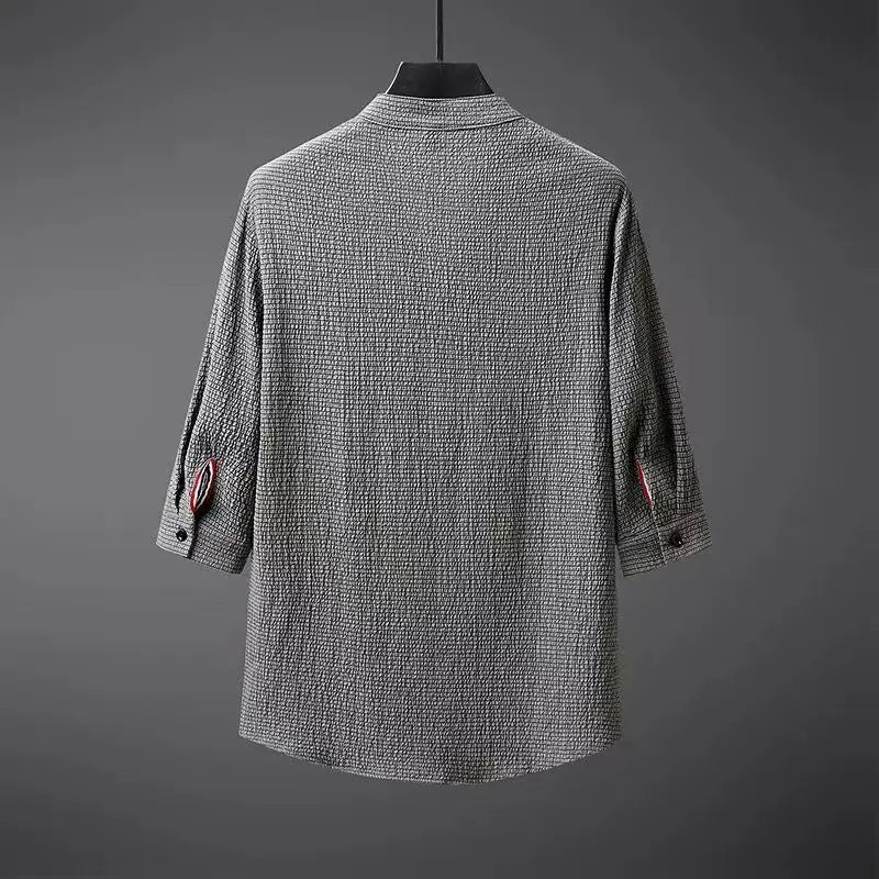 Back view of gray textured cotton linen men's shirt with rose embroidery detail on rolled sleeves, three-quarter length