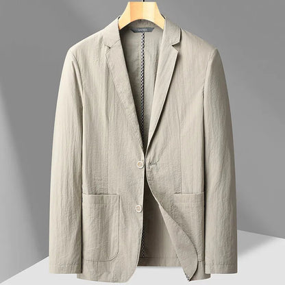 Light khaki men's two-button blazer with notch lapels, patch pockets, and textured fabric on a wooden hanger