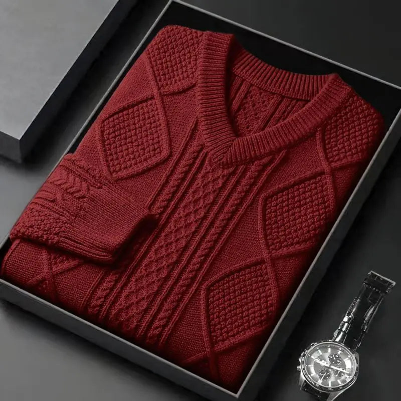 Red cable knit V-neck wool sweater for men, neatly folded in a gift box with a watch beside it.