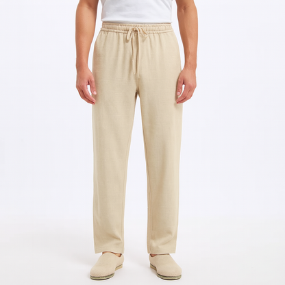 Men's beige cotton drawstring pants with elastic waist and relaxed fit on white background