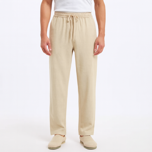 Men's beige cotton drawstring pants with elastic waist and relaxed fit on white background