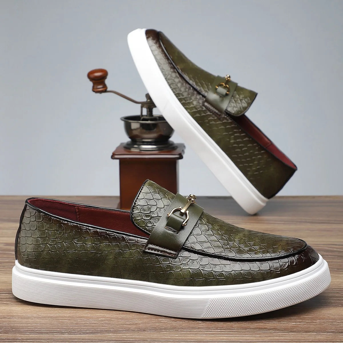 Green crocodile-embossed leather slip-on loafers with gold horsebit buckle and white platform sole for men