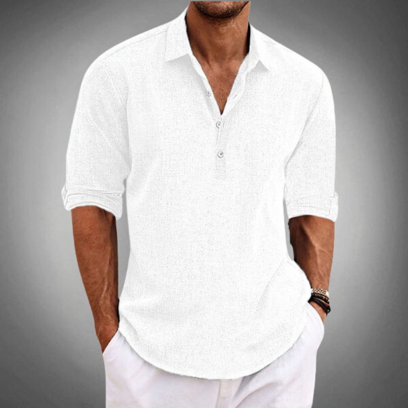 Men's white linen Henley shirt with rolled sleeves, button placket, spread collar, paired with white pants.