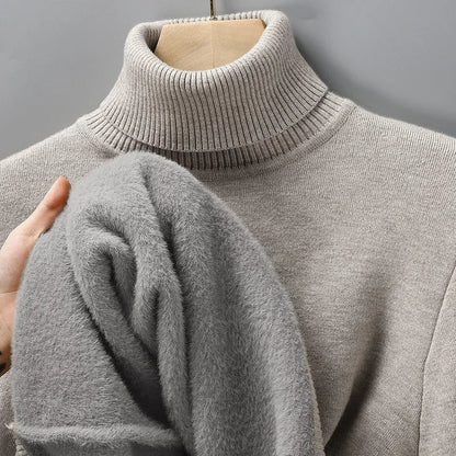 Light gray men's merino wool turtleneck sweater displayed on mannequin, showing plush fleece interior lining.