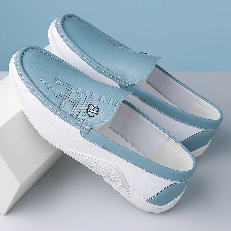 Light blue and white leather slip-on loafers with decorative stitching and comfortable flat sole for men