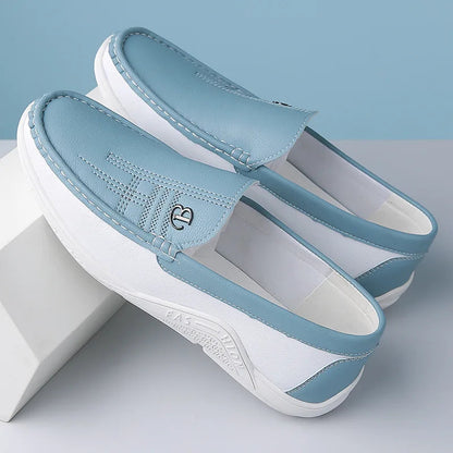 Light blue and white leather slip-on loafers with decorative stitching and comfortable flat sole for men