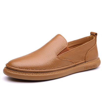 Tan brown men's leather slip-on loafers with textured upper, elastic side panels, and stitched flat sole