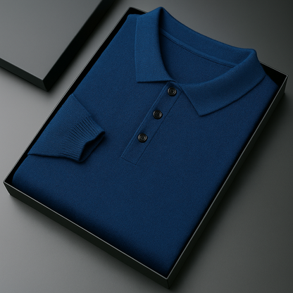 Folded navy blue merino wool long sleeve men's polo sweater with three buttons, displayed in a black gift box.