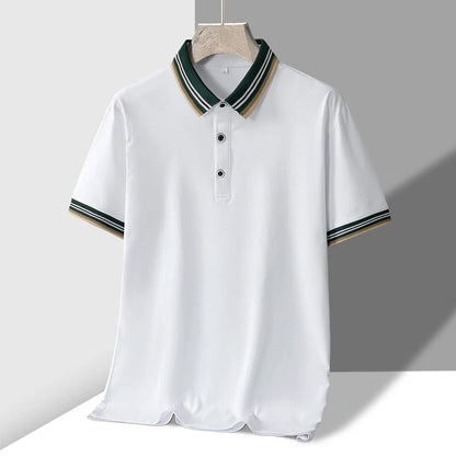 White men's polo shirt with green and tan striped collar and cuffs, two snap buttons, short sleeves, on hanger