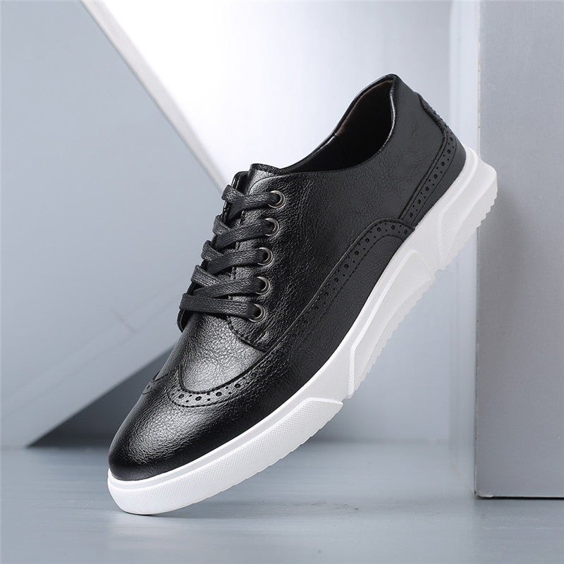 Black leather brogue lace-up sneakers with white rubber sole, featuring perforated detailing on toe cap and sides.