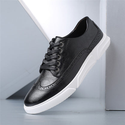 Black leather brogue lace-up sneakers with white rubber sole, featuring perforated detailing on toe cap and sides.
