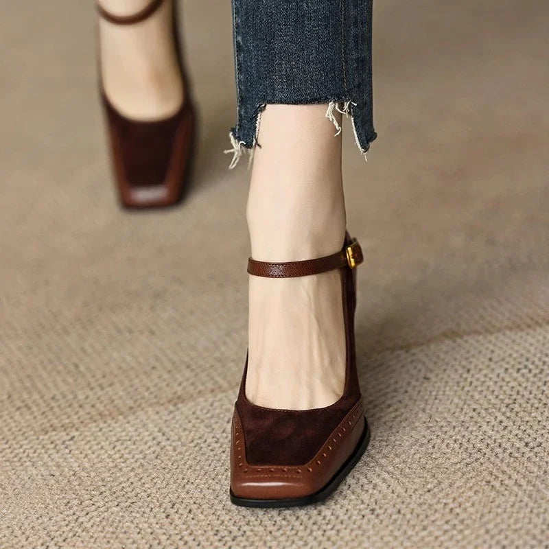 Brown square toe leather block heel pumps with ankle strap buckle, worn with cropped distressed jeans.
