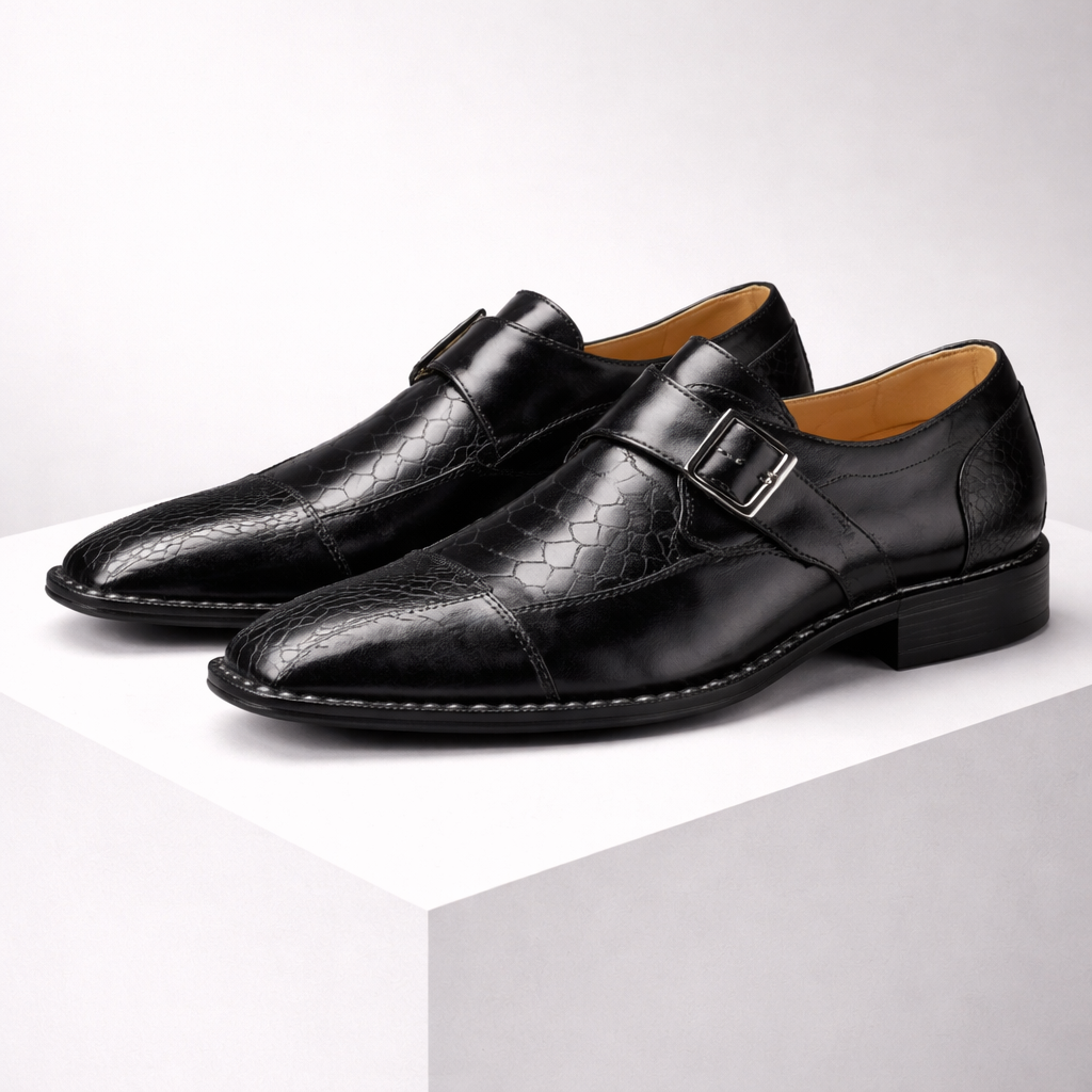 Black leather monk strap dress shoes with silver buckle and crocodile-embossed cap toe detail for men