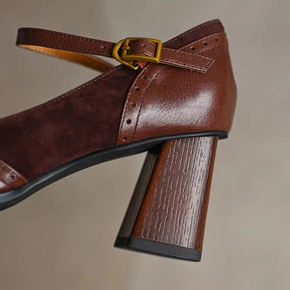 Brown leather block heel pumps with square toe, ankle strap, gold buckle, and wood-textured chunky heel detail.