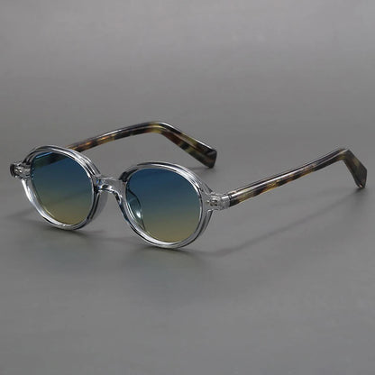 Round frame sunglasses with clear crystal acetate frames, blue-yellow gradient lenses, and brown tortoiseshell temple arms.