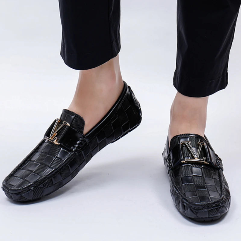 Black checkered slip-on loafers for men with gold metal buckle detail and textured pattern driving shoes