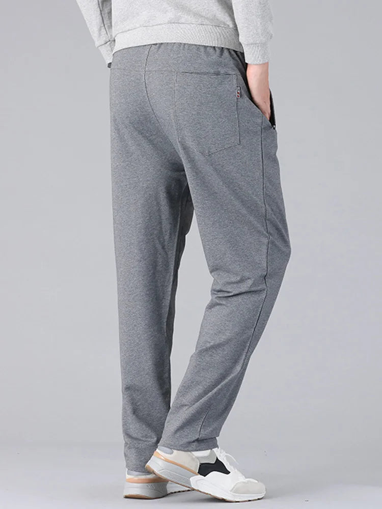 Men's gray cotton drawstring sweatpants with pockets and relaxed fit, rear view