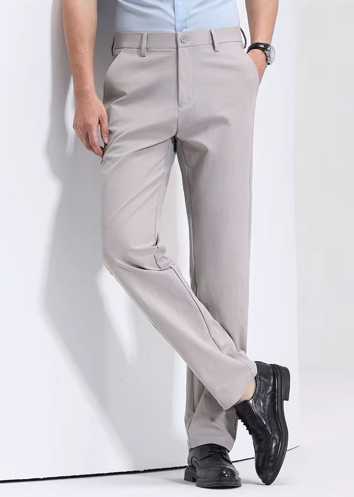 Man wearing light gray Viero slim-fit cotton dress trousers paired with a light blue shirt and black oxford shoes.