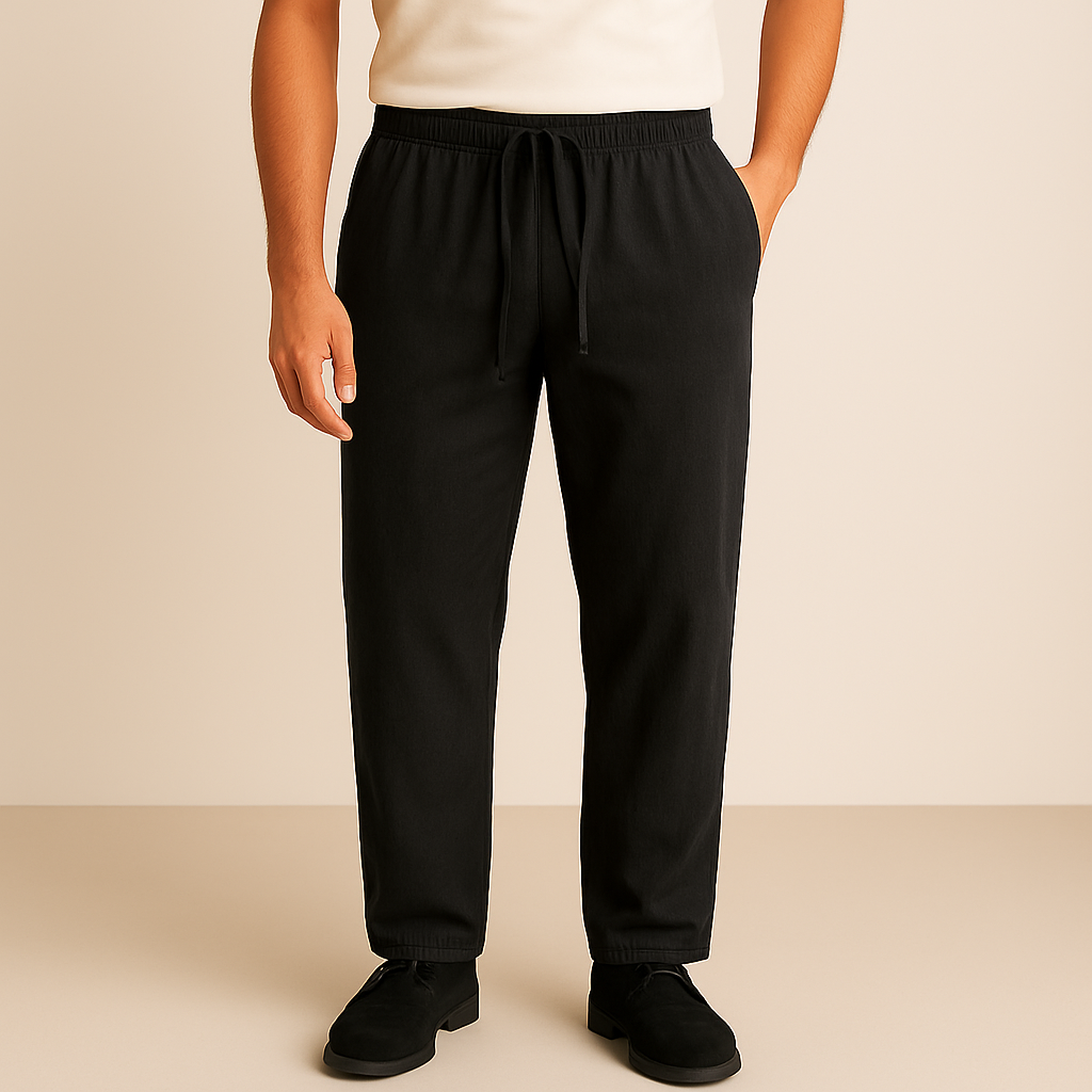 Man wearing black linen-cotton drawstring pants with elastic waistband, paired with a white tee and black shoes.