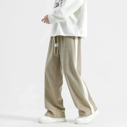 Wide-leg beige corduroy joggers with drawstring waist and white sneakers for men streetwear fashion