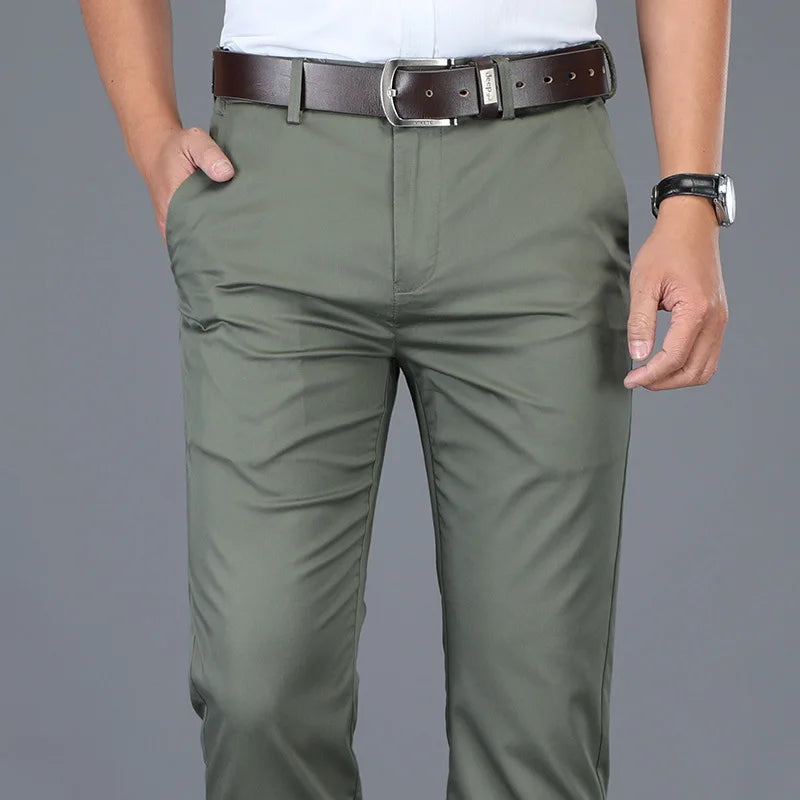 Men's olive green slim fit dress pants with brown leather belt and white shirt