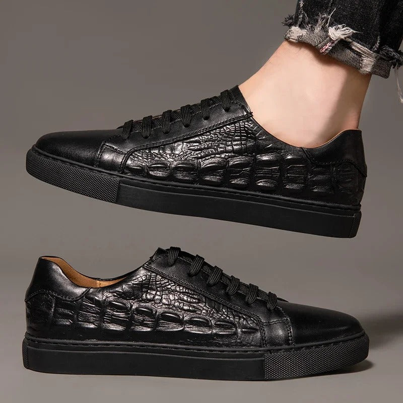 Black men's leather lace-up sneakers with crocodile embossed texture pattern on thick rubber sole