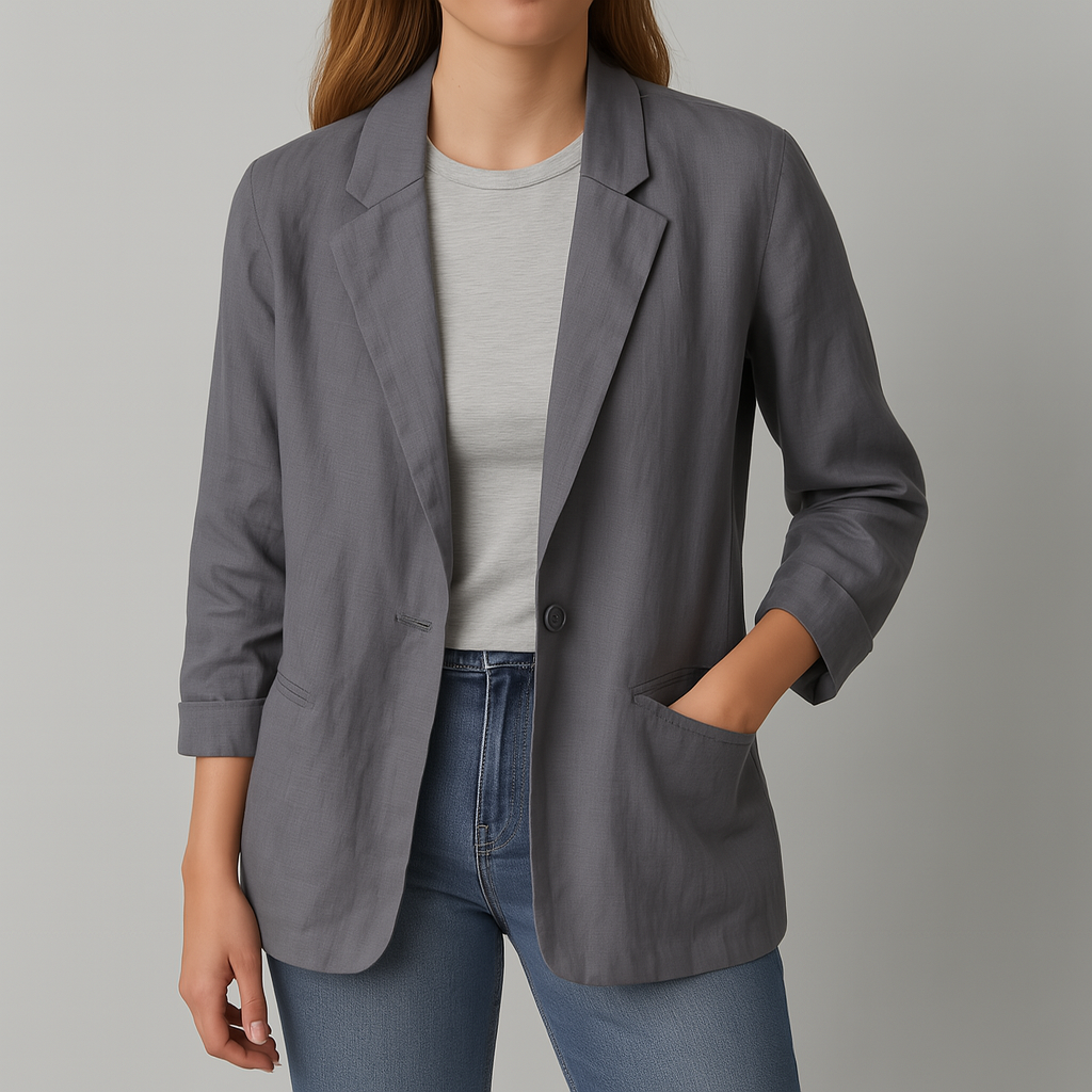 Women's gray linen blazer jacket with notch lapels, rolled sleeves, front pockets, worn open over white tee and blue jeans.