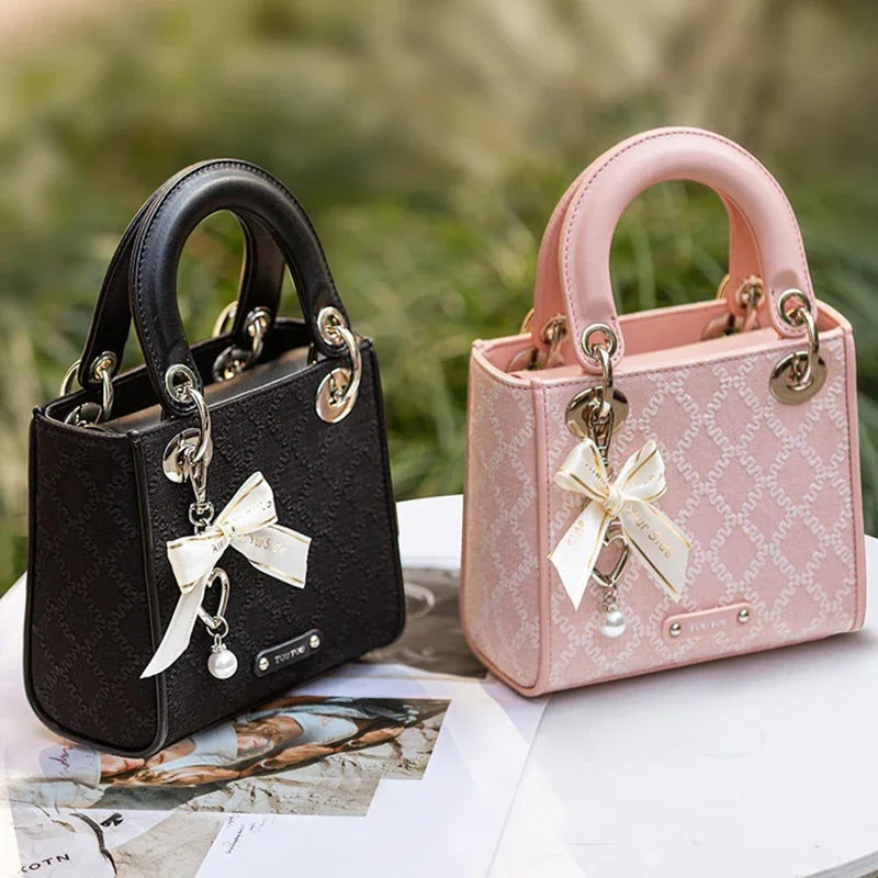 Elegant jacquard mini handbag with bow charm and pearl accent in black and pink colors for women