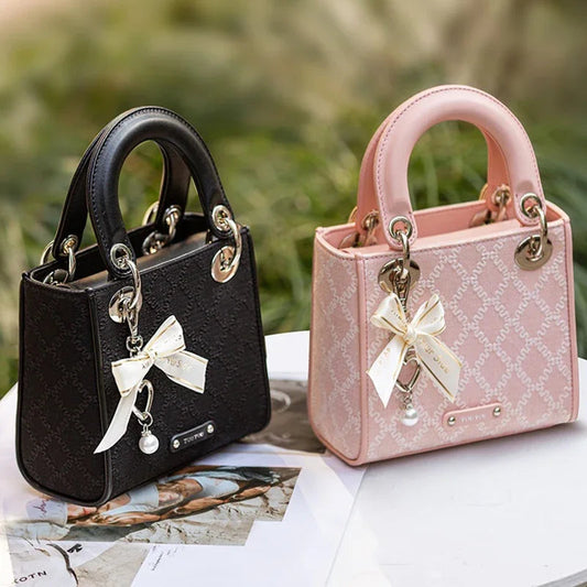 Elegant jacquard mini handbag with bow charm and pearl accent in black and pink colors for women