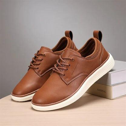 Brown leather lace-up casual shoes for men with white sole and pull tab, displayed on books