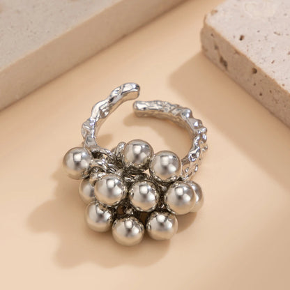 Silver adjustable open-band ring featuring a cluster of polished metallic spherical beads on a textured band.