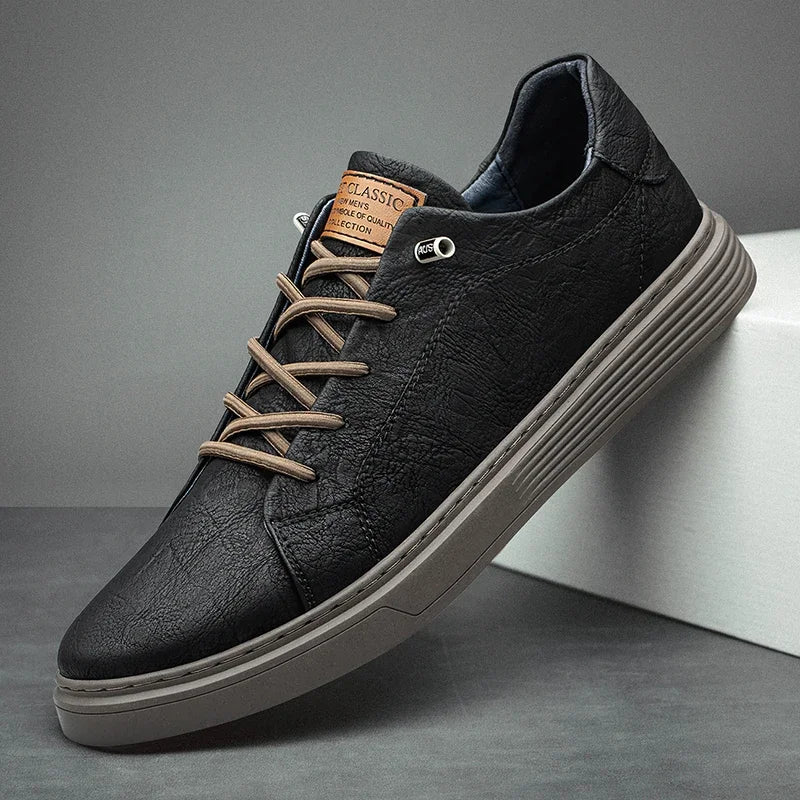 Black leather low-top sneakers with tan laces and grey sole for men - classic casual footwear
