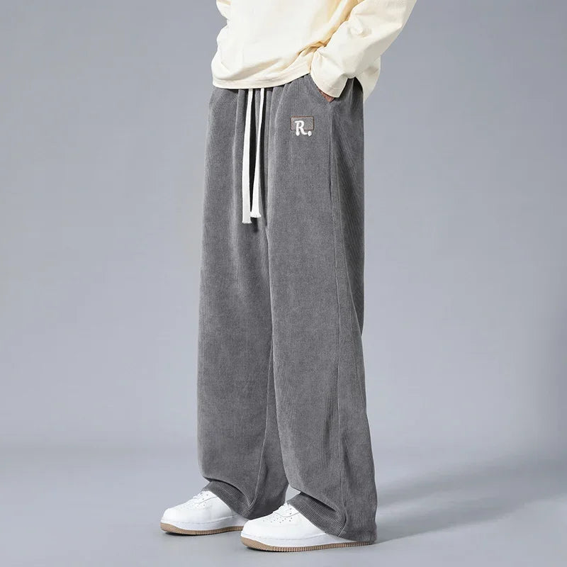 Men's gray wide-leg corduroy sweatpants with white drawstring and R logo patch, casual loose fit pants