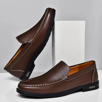 Brown men's leather slip-on loafers with contrast stitching, low heel, and tan interior lining, shown from two angles.
